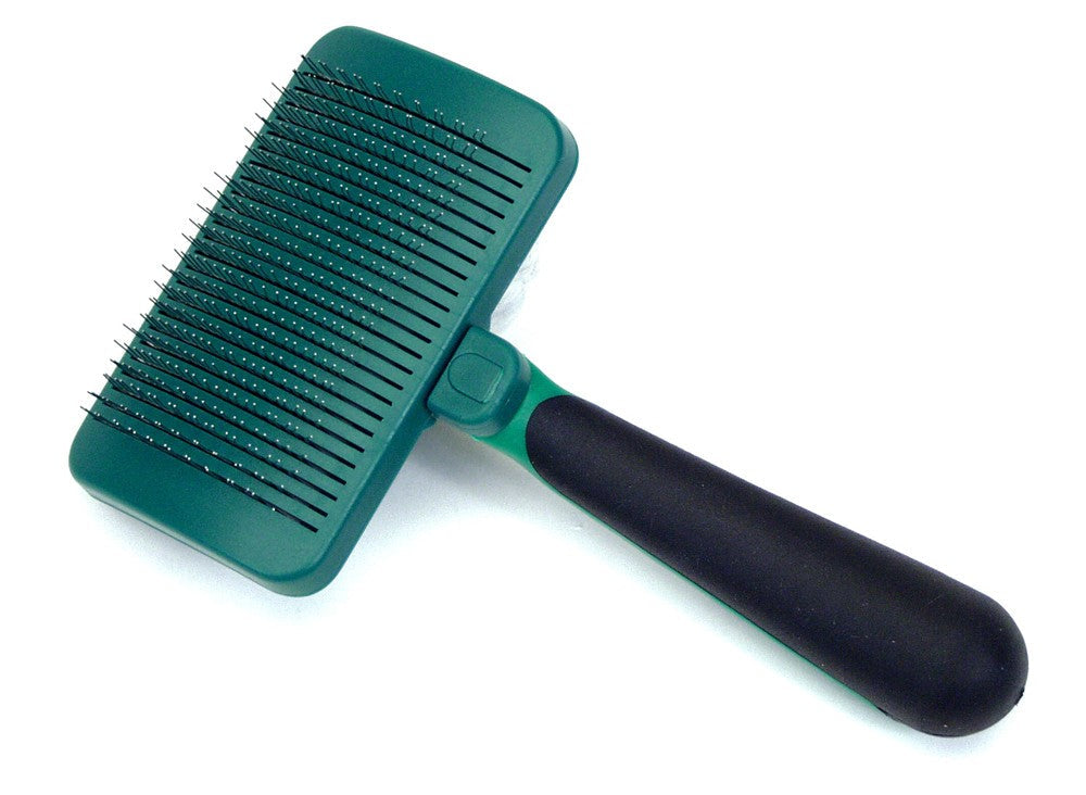 Green pet grooming brush with black handle on a white background